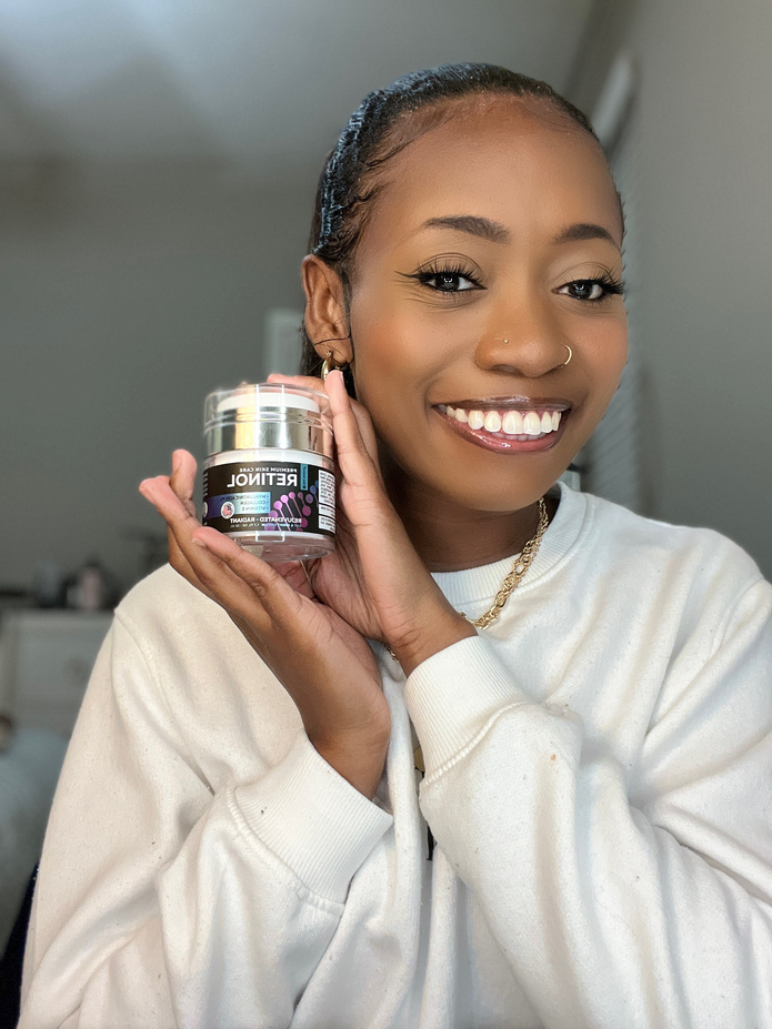 UGC creator smiling and holding a skincare product
